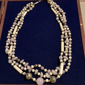 Triple strand pale purple polished stone and gunmetal beaded necklace